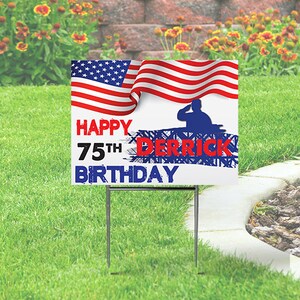 May include: A white yard sign with the American flag and the words "HAPPY 75TH BIRTHDAY DERRICK" in red and blue. A silhouette of a saluting soldier is also featured. The sign is displayed on a green lawn.
