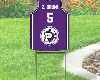 Puede incluir: Camiseta de baloncesto morada con el nombre "Z. BRUNI" y el número "5" en la espalda. La camiseta tiene un logotipo con la letra "P" y las palabras "CONFLICT, CULTURE, COMMITMENT, COMMUNITY, CONNECTION" alrededor.