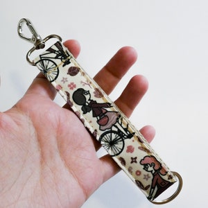 Girls riding Bicycle patterned Keychain - Vintage colors