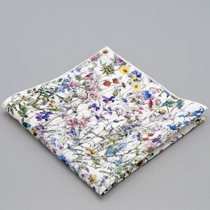 May include: A white cotton handkerchief with a floral print featuring a variety of colorful flowers and leaves.