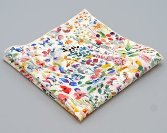 May include: A white cotton handkerchief with a colorful floral pattern. The pattern features a variety of flowers in shades of pink, red, blue, yellow, and green.