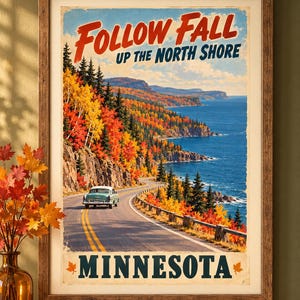 May include: A framed wall art print titled Follow Fall Up The North Shore Minnesota featuring a vintage teal car driving along a winding coastal road lined with vibrant orange, yellow, and red autumn trees overlooking a deep blue lake.