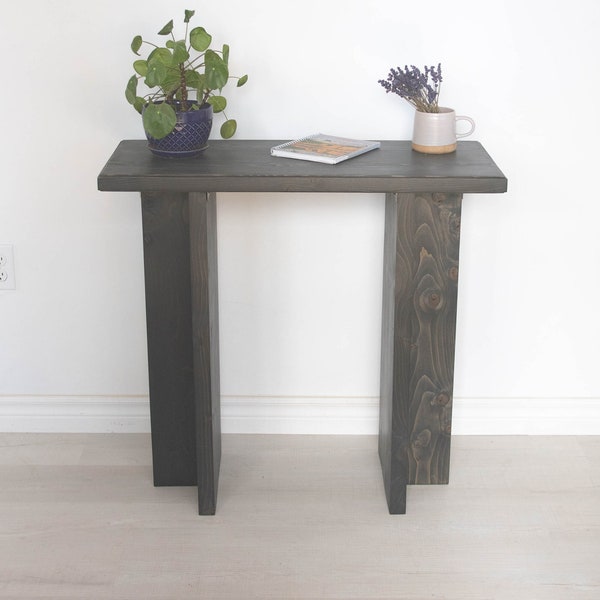 Modern black side table. 30" tall modern black side table with contemporary design features.
