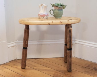 Unique farmhouse oval top tripod table. Rustic reclaimed barn wood tripod nightstand with black striped legs
