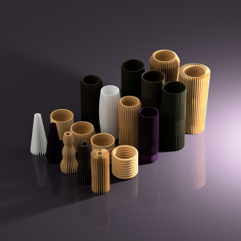 May include: A collection of 14 decorative cylindrical vases in various colors and patterns, including black, white, brown, and green. The vases are made of different materials, such as wood and ceramic, and have a variety of textures, including smooth, ribbed, and textured.