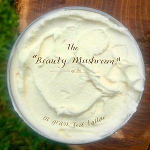 May include: A white jar of body butter with the text "The "Beauty Mushroom" in grass-fed tallow" on the label.