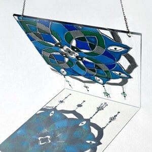 Painted on a 20×15 cm acrylic sheet (plexiglass) which is more durable and lighter than glass, makes it suitable for hanging on the window.