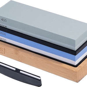 May include: A set of three sharpening stones with a bamboo base and a honing steel. The stones are labeled 400, 1000, 3000, and 8000 grit.