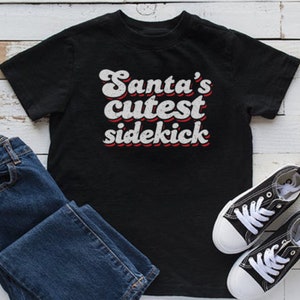 Santa's Cutest Sidekick Christmas Funny T-Shirt, Funny Christmas T-Shirt, Family Christmas T-Shirt, Short-Sleeve Unisex T-Shirt