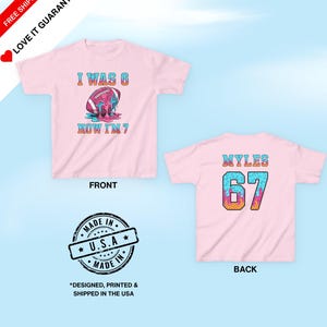 May include: Pink t-shirt with a football graphic and the text "I WAS 6 NOW I'M 7" on the front. The back of the shirt has the name "MYLES" and the number "67". The shirt is designed, printed, and shipped in the USA.