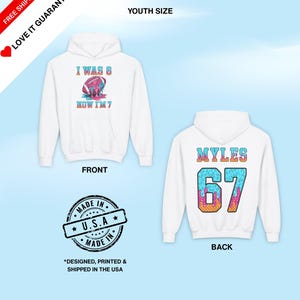 May include: White youth-sized hoodie with a football graphic that reads "I WAS 6 NOW I'M 7" on the front. The back of the hoodie has the name "MYLES" and the number "67". The hoodie is designed, printed, and shipped in the USA.
