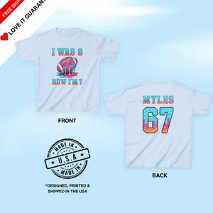 May include: White t-shirts with colorful graphics. One shirt has a football design with the text "I WAS 6 NOW I'M 7". The other shirt has the name "MYLES" and the number "67". The shirts are labeled "FRONT" and "BACK".