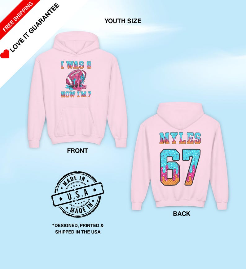 May include: Pink youth-sized hoodie with a front graphic that reads "I WAS 6, NOW I'M 7" and a football design. The back of the hoodie displays "MYLES 67". The hoodie is made in the USA.