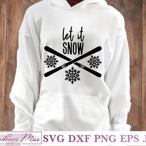 May include: White hoodie featuring the text "Let it Snow" in black, with crossed skis and snowflakes. The bottom of the hoodie has the text "Madison Mae Designs" and file type options.