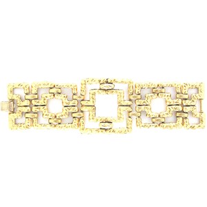 May include: A gold-toned bracelet with a geometric design. The bracelet is made of interlocking squares.