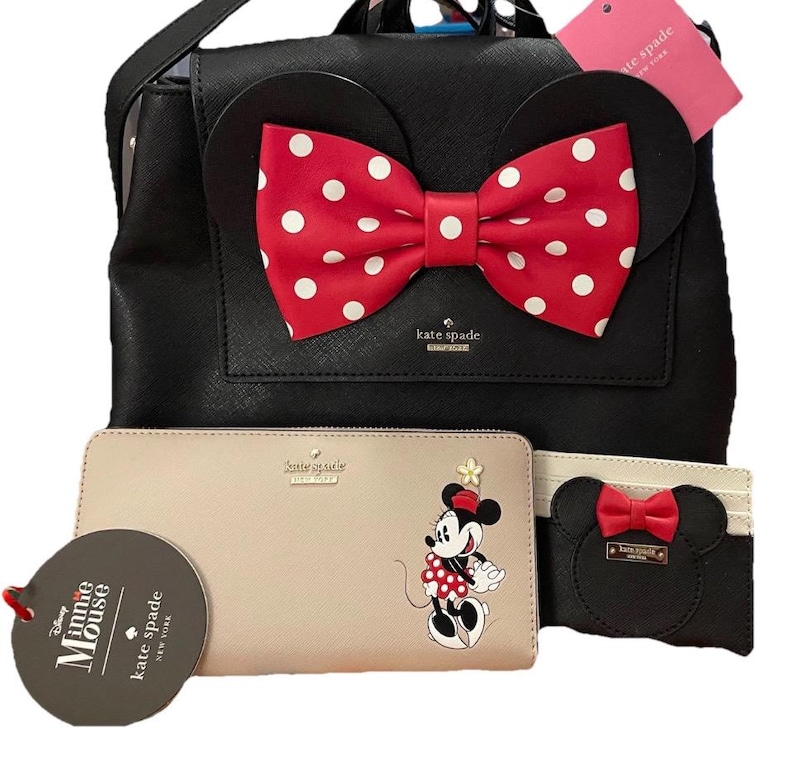 May include: A white ceramic mug with a black handle and the text "But First, Coffee" in a black, handwritten-style font. The mug is on a white surface.