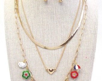 Conjunto de collar y pendientes con diseño de margaritas, paraguas, flores, arcoíris, corazón y caritas sonrientes doradas con temática de jardín, triple capa, ajustables, 111 unidades