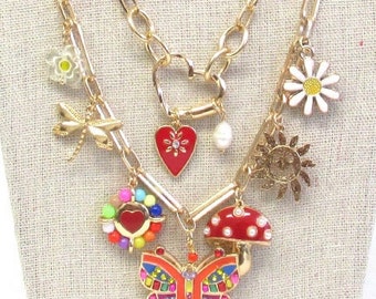 Gold multi charm double layer necklace with mushroom butterfly daisy charms set with stud earrings