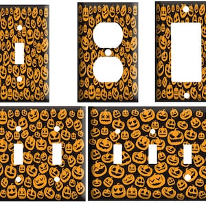 May include: Set of five Halloween-themed light switch and outlet covers. The covers feature a black background with a repeating pattern of orange jack-o'-lantern faces.