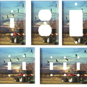 May include: A set of five light switch and outlet covers featuring a red tractor driving through a field with a blue sky and geese flying overhead.