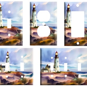 May include: Set of five light switch and outlet covers featuring a watercolor painting of a lighthouse on a rocky shore with a blue sky and ocean in the background.