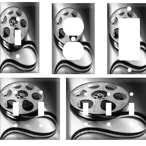 May include: A set of six light switch covers featuring a black and white film reel design. The covers are made of durable plastic and are easy to install.