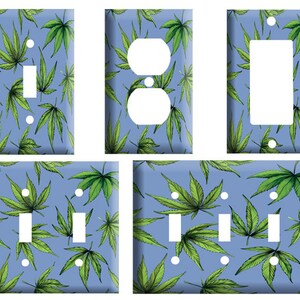 May include: A set of light blue electrical switch plates featuring a repeating pattern of green cannabis leaves. The plates include single and double switch covers, a double outlet cover, and a single rocker switch cover.