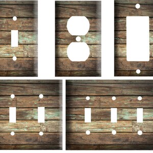 May include: Set of four light switch and outlet covers featuring a rustic woodgrain design with a distressed, weathered look. The covers are in various sizes, including single switch, double switch, and outlet.