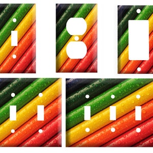 May include: A set of colorful light switch and outlet covers featuring a close-up of colorful striped plastic tubes with water droplets. The colors are green, yellow, orange, and red.