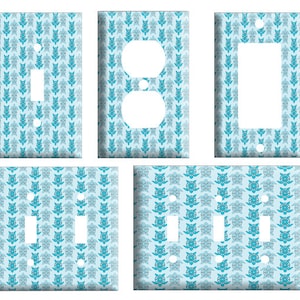 May include: Set of four light blue and teal patterned wall plates for light switches and outlets. The plates feature a repeating pattern of stylized sea turtles.