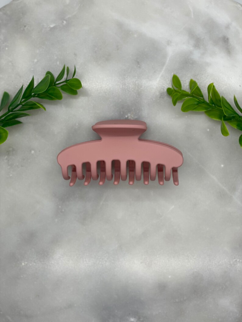 Peut inclure: Une grande pince &agrave; cheveux en or rose. La pince a une finition lisse et mate et est con&ccedil;ue pour tenir les cheveux &eacute;pais ou longs.