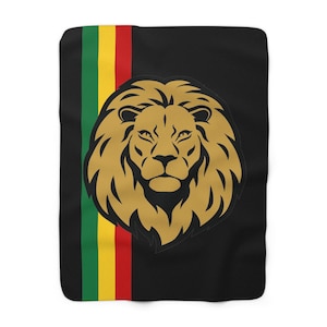 May include: Black blanket featuring a gold lion's head emblem. A vertical stripe of green, yellow, and red runs along the left side. The lion's head is centered and detailed, with a regal expression.