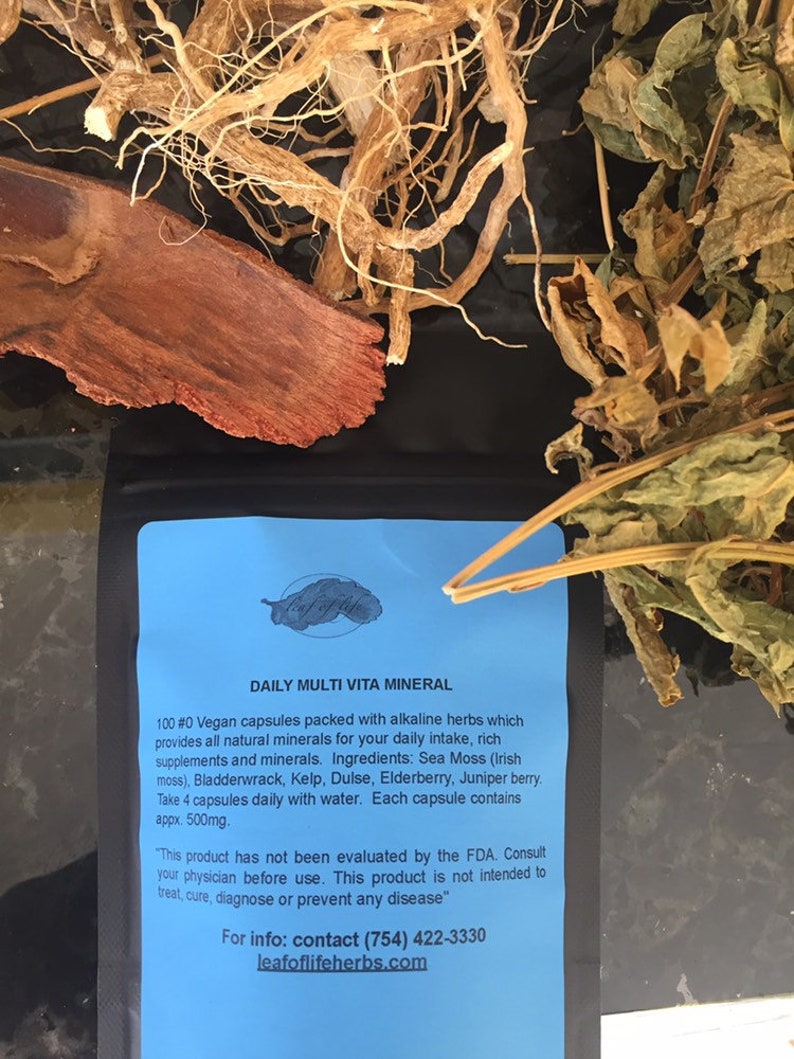 May include: A blue and white label with the text "DAILY MULTI VITA MINERAL" and information about a vegan supplement containing alkaline herbs and minerals. The label is on a black background with dried herbs and roots.
