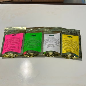 May include: Four foil pouches with different colored labels: pink, green, white, and yellow. Each pouch contains text and a small green image. The pouches are labeled: Alkaline Blood Cleanser, Intracellular Cleanser & Detox, Lymphatic Cleanser, and Detox Gut and Cell Cleanser.