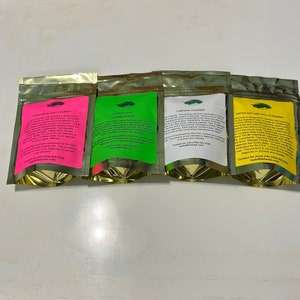 May include: Four foil pouches with colorful labels. The labels are pink, green, white, and yellow, each with text. The pouches are labeled "Alkaline Blood Cleanser", "Intracellular Cleanser", "Lymphatic Cleanser", and "Detox Gut and Cell Cleanser".