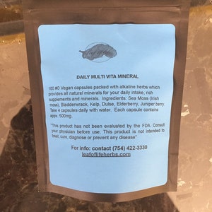 May include: Blue and white label with the text "DAILY MULTI VITA MINERAL" and information about vegan capsules packed with alkaline herbs. The label also includes the text "leafoflifeherbs.com" and a phone number.