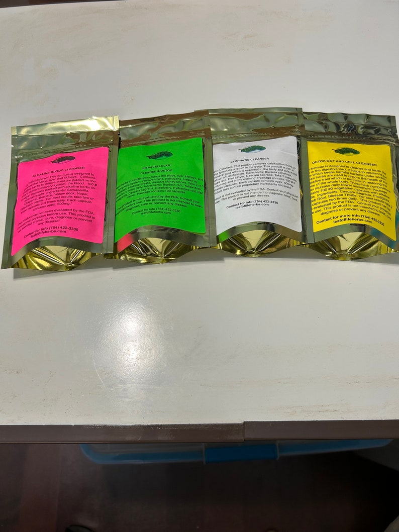 May include: Four gold foil pouches with colorful labels. The labels are pink, green, white, and yellow, each with text and a small illustration. The pouches are for different types of cleansers, including blood, intracellular, lymphatic, and gut/cell.