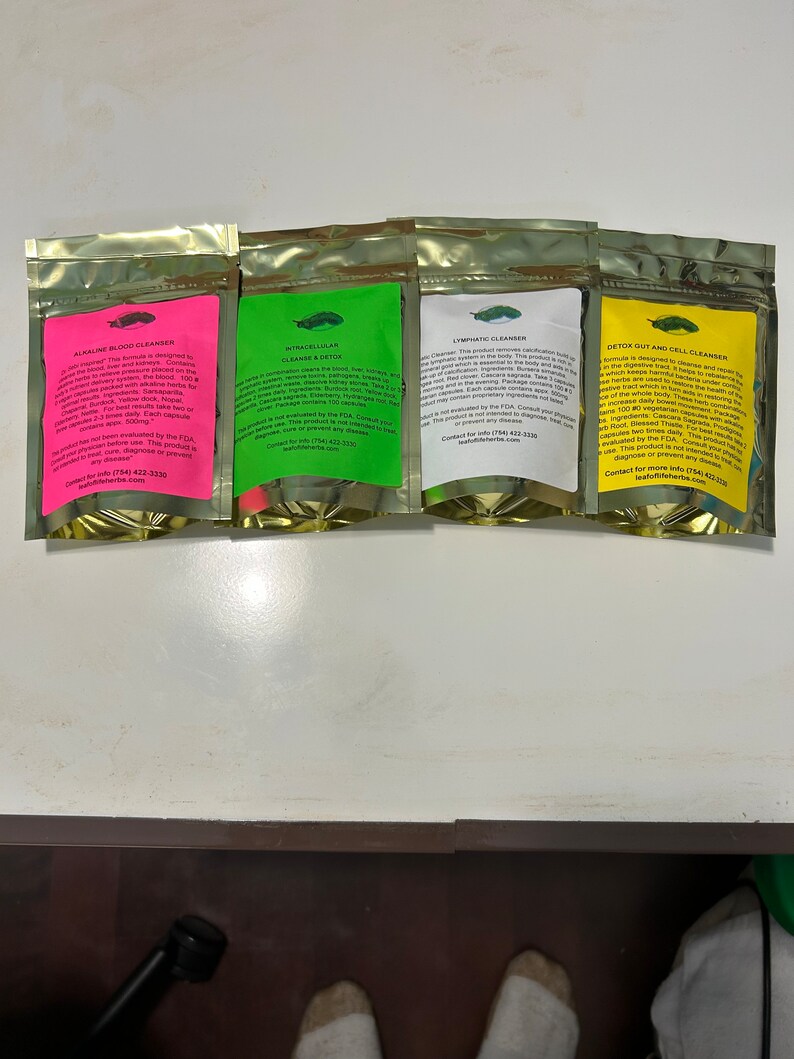 May include: Four sealed pouches with colorful labels, each containing a supplement. The labels are pink, green, white, and yellow, and feature text and a small illustration. The pouches are arranged in a row.