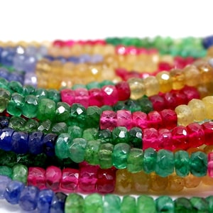 May include: A strand of faceted gemstone beads in various colours, including yellow, green, blue, and red. The beads are arranged in a repeating pattern, creating a colourful and eye-catching display.