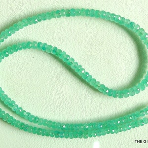 May include: A strand of light green gemstone beads with a silver clasp. The beads are faceted and have a slightly irregular shape. The necklace is approximately 18 inches long.