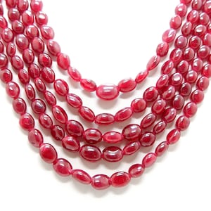 Può includere: Una collana multifilo realizzata con perline di rubino rosso ovali.