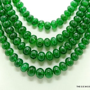 May include: A strand of emerald green gemstone beads, with five rows of beads, each row with a slightly different size bead. The beads are round and smooth, with a polished finish.