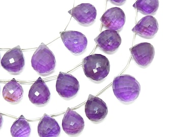 May include: A strand of purple amethyst gemstone beads in a faceted teardrop shape. The beads are strung on silver wire.
