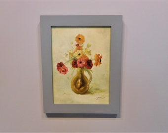 May include: A framed painting of a still life featuring a vase of colorful flowers. The vase is a golden brown color and the flowers are red, orange, yellow, and white. The painting is signed "A. Masuda 1971" in the lower right corner.