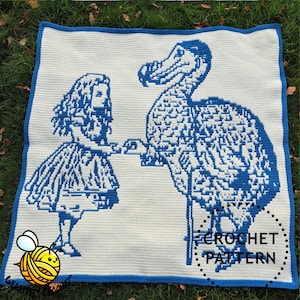 May include: A crocheted blanket with a blue and white design depicting Alice in Wonderland and a Dodo bird. The blanket has a blue border and the words "CROCHET PATTERN" are visible. The blanket is on a green surface.