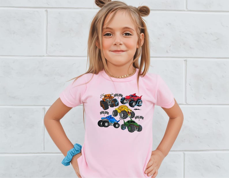 A cream-colored baby bodysuit featuring a colorful graphic of five different monster trucks in orange, red, yellow, blue, and green, along with checkered racing flags.