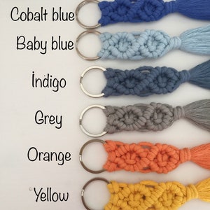 May include: Six keychains with silver key rings and tassels. The keychains are made of macrame cord in the following colors: cobalt blue, baby blue, indigo, grey, orange, and yellow.