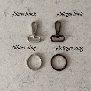 May include: Two silver and two antique metal hooks and rings. The silver hook and ring are on the left, and the antique hook and ring are on the right. The silver hook and ring are both shiny, while the antique hook and ring are both dull and have a brown patina. The text 'Silver hook', 'Silver ring', 'Antique hook', and 'Antique ring' are written below each item.