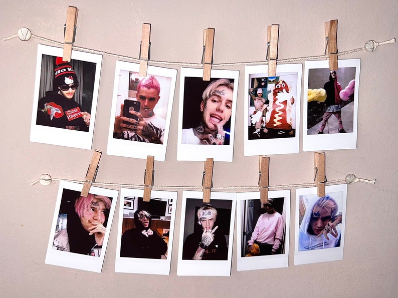 May include: A wall display of ten Polaroid photos featuring a young man with pink hair. The photos are hung on a string with clothespins.