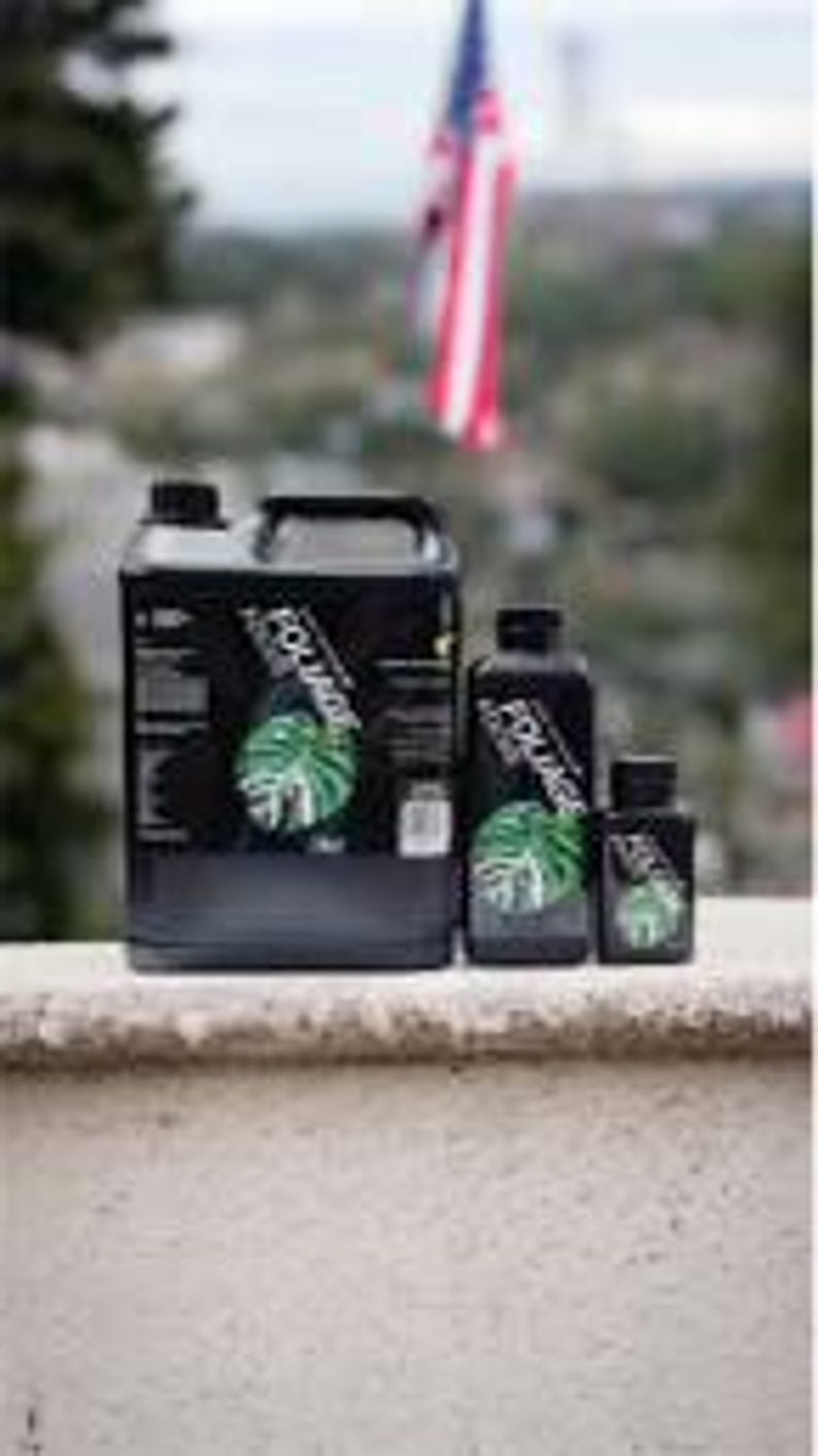 May include: Four bottles of plant fertilizer in different sizes. The bottles are black with a green leaf design and the word "Monstera" printed on the label.